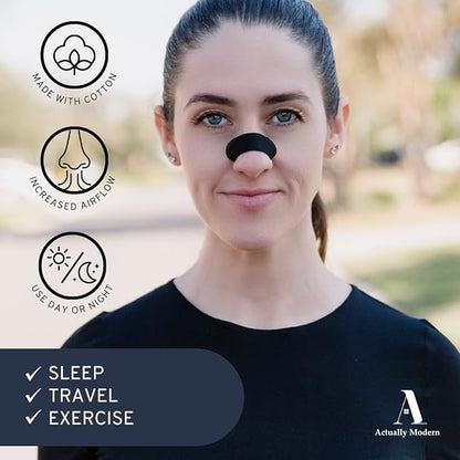 Image shows a brunette woman with a black nose strip on her nose looking at the camera. There are three icons with the text, "Made With Cotton," "Increased Airflow," and "Use Day or Night." There's three checks with the text, "sleep," "travel," and "exercise."